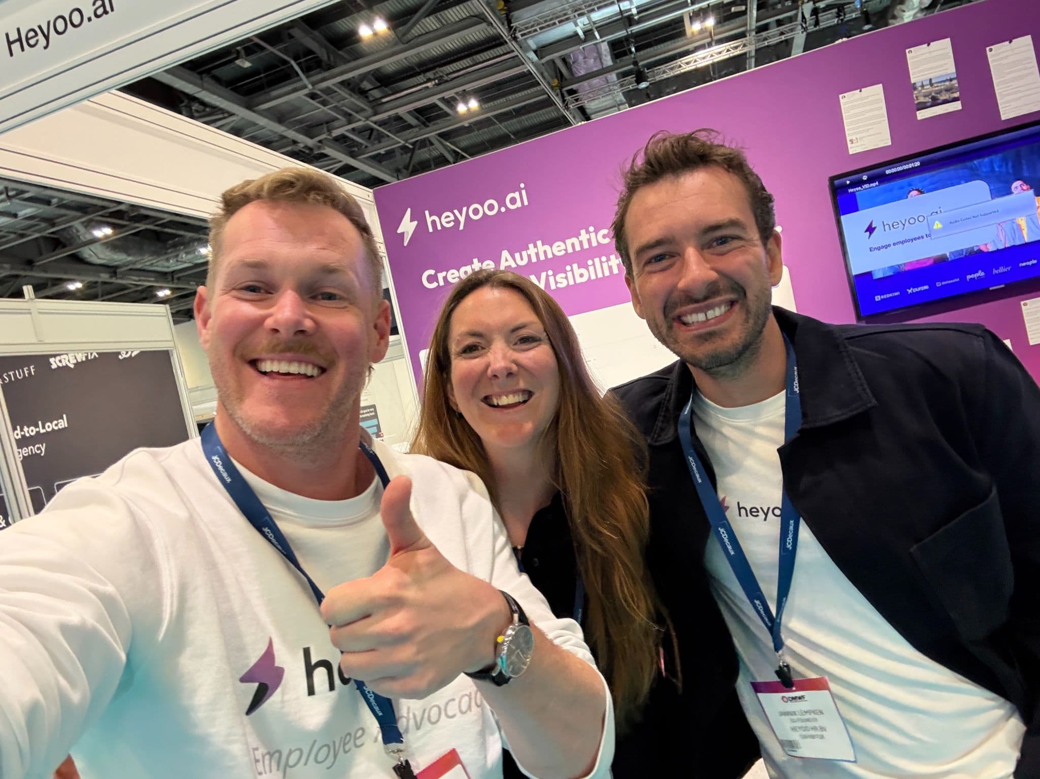 Three members of the Heyoo team at their stand at DMWF London