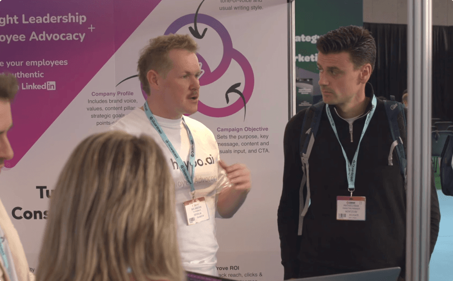 A Heyoo team member talking to a visitor at the DMWF stand