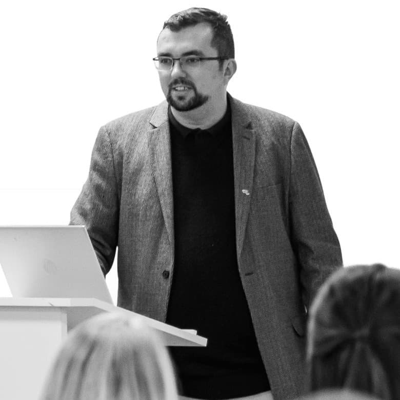 Kristian Downer, founder of DowSocial, speaking at a lectern