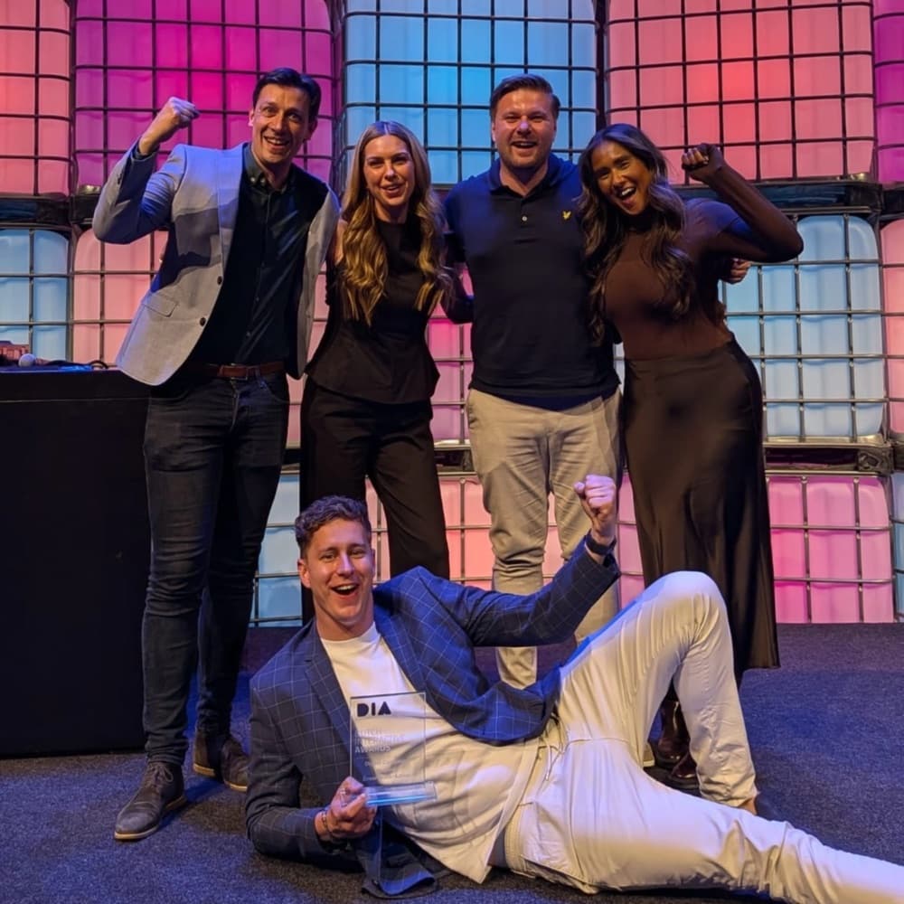 The Redkiwi team celebrating an award win on stage