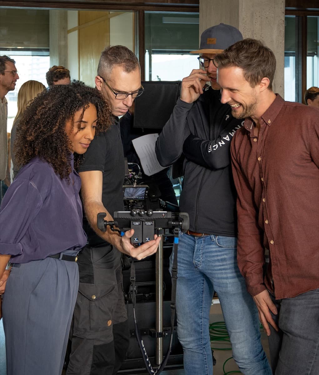 The Trenchcoat crew reviewing a shot on a camera monitor