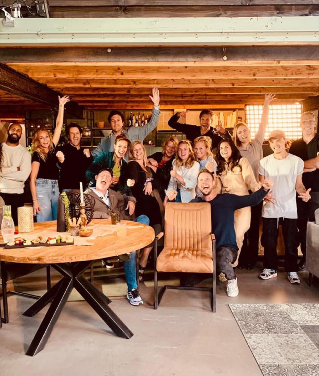 The Trenchcoat team cheering together in their studio